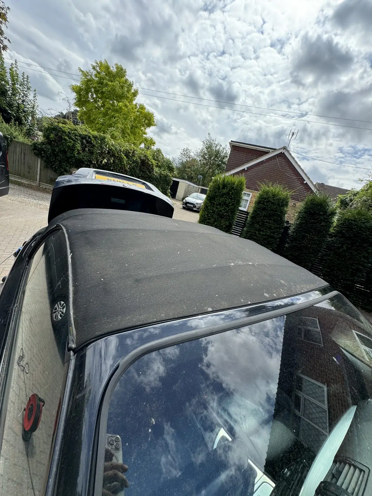 A second cabriolet fabric roof before cleaning, discoloured and contaminated