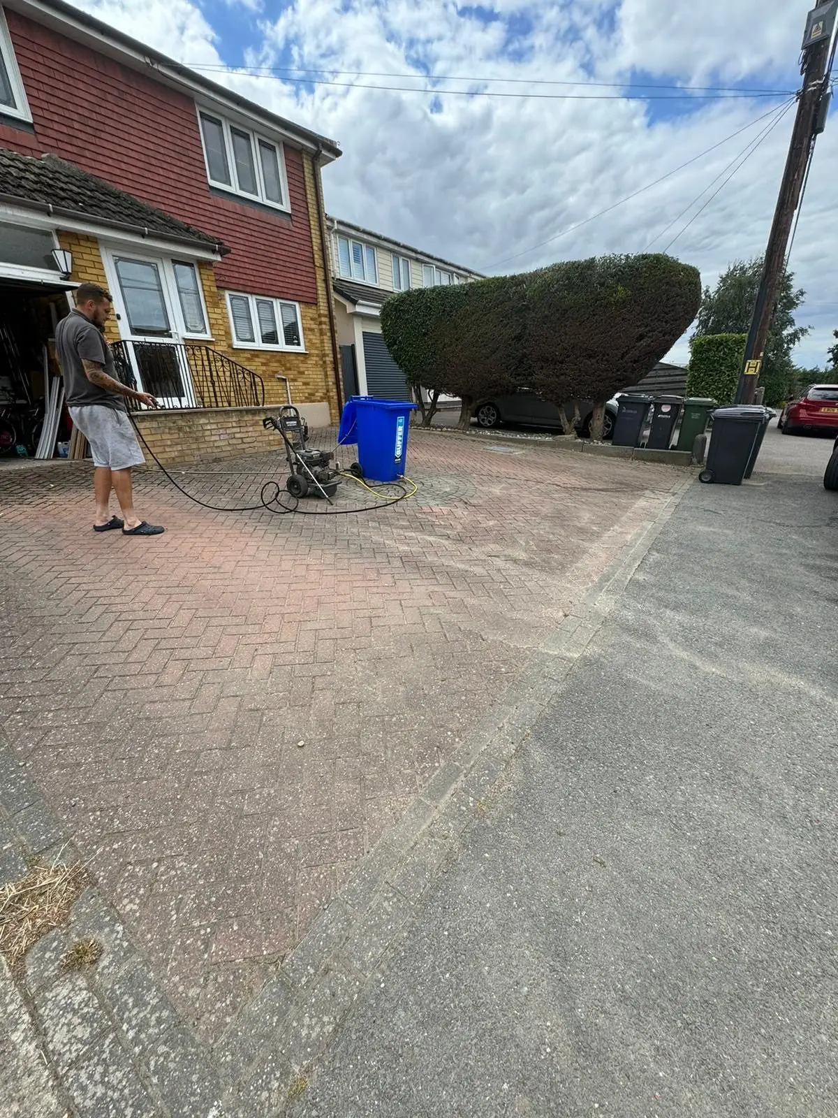 Red block paving driveway before cleaning, soiled and discoloured