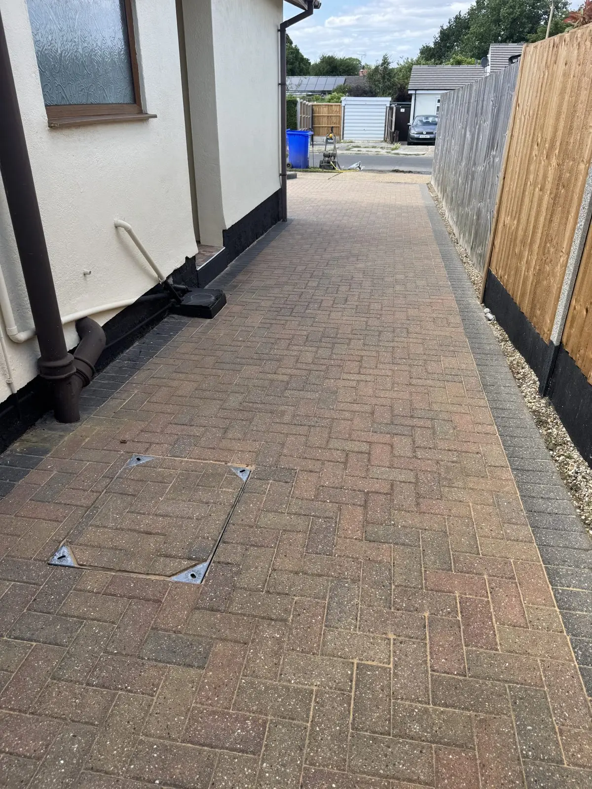 Second angle of the same driveway after cleaning, fully restored