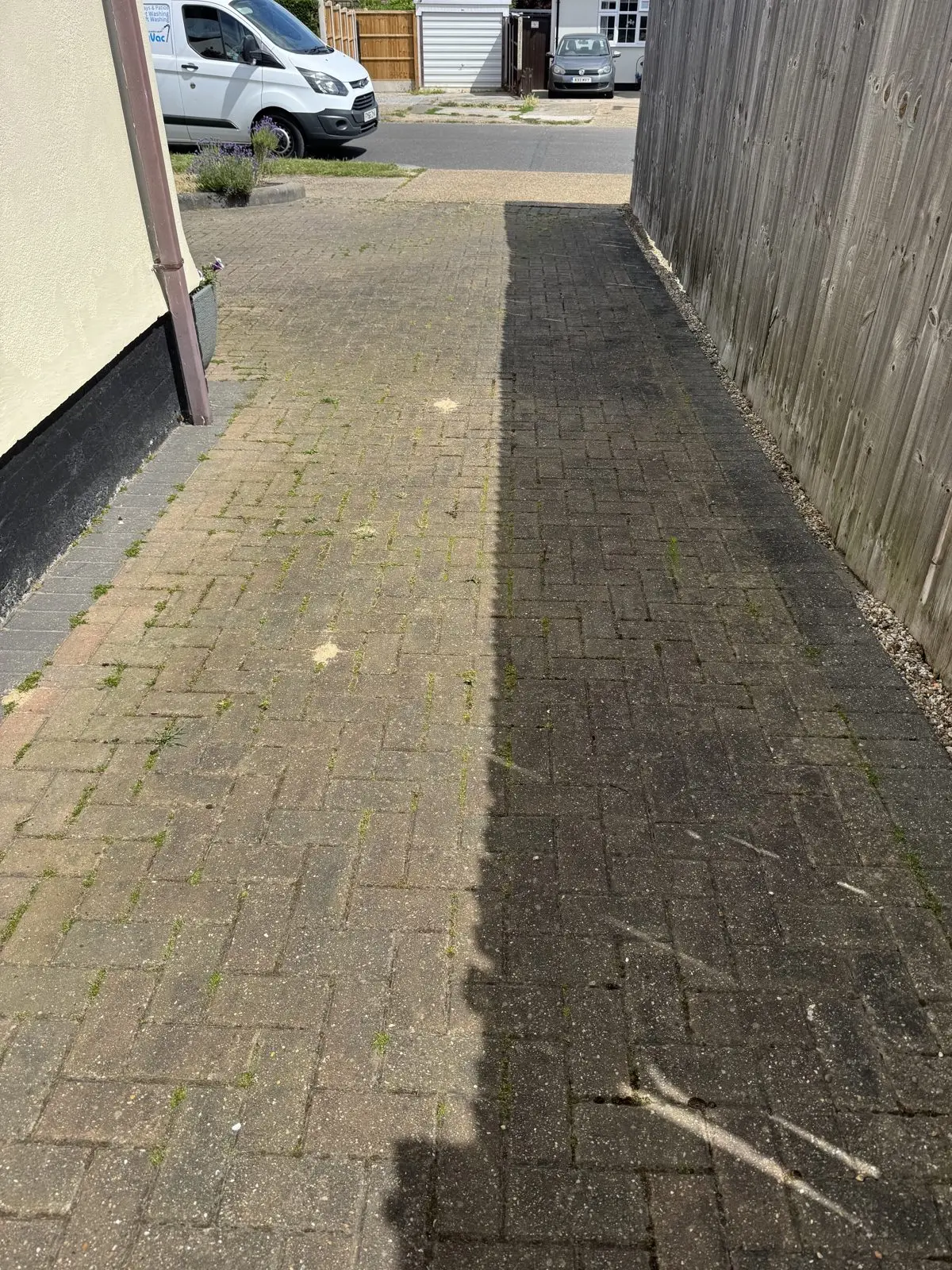 Second angle of the moss-covered block paving driveway before cleaning
