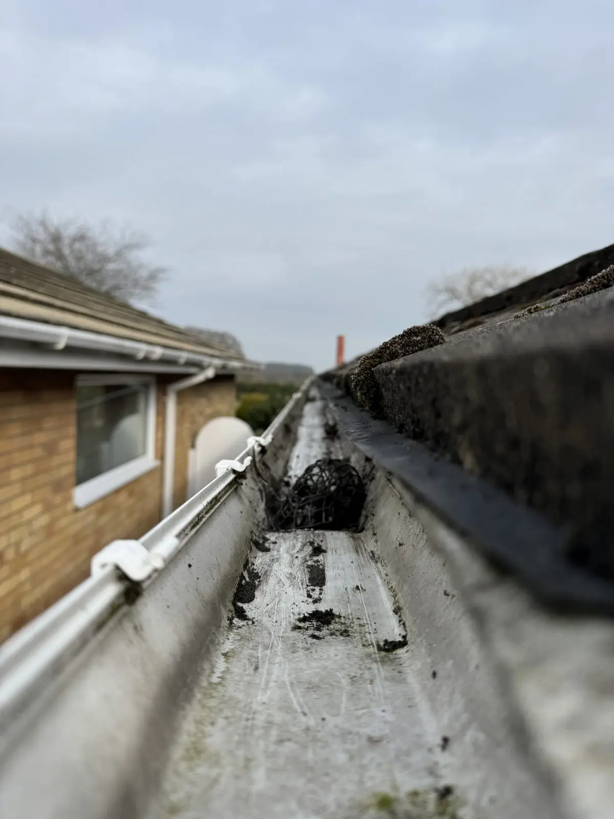 The same gutter after clearing, debris removed and draining properly