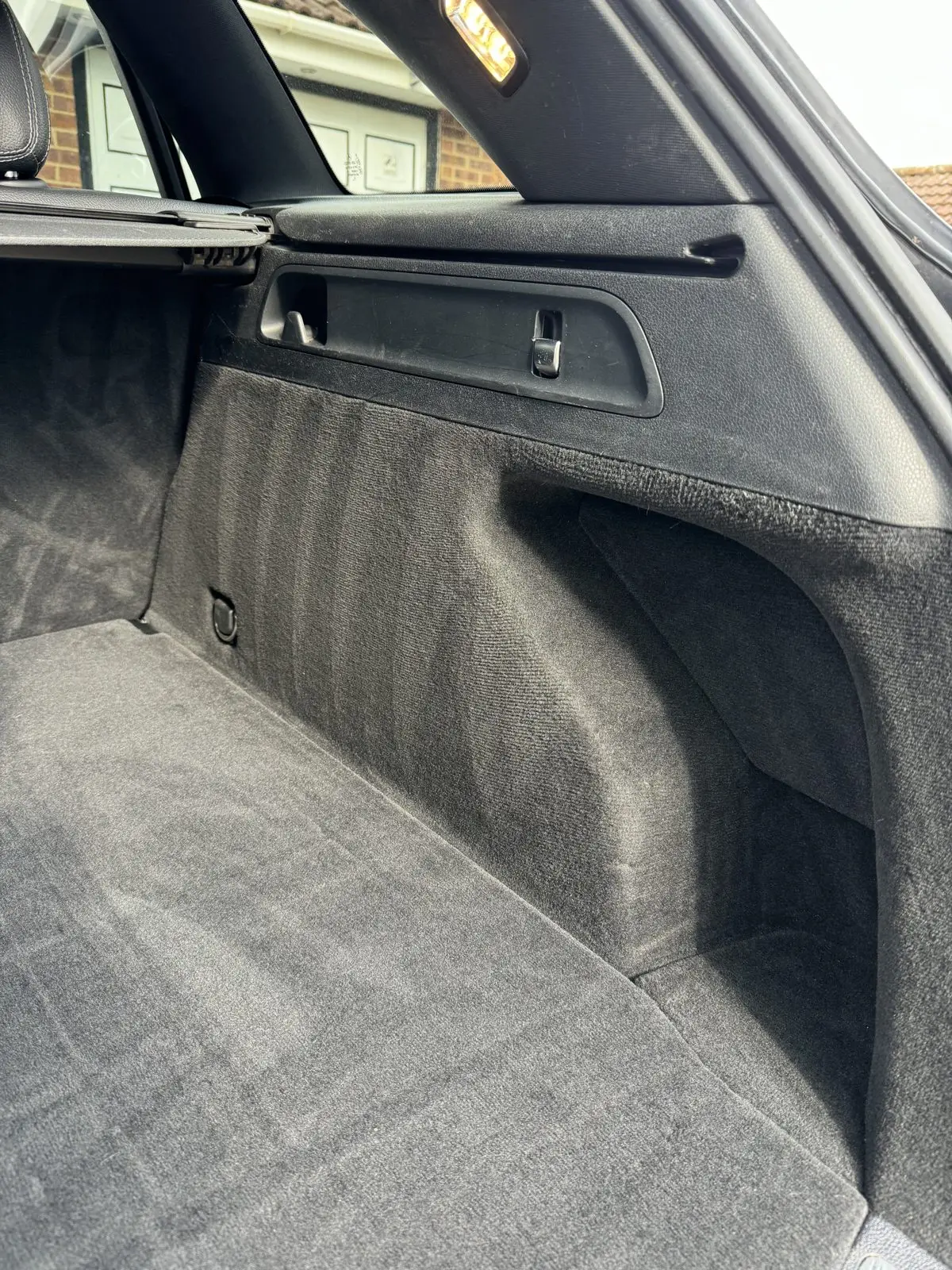 The same car boot after a deep clean, carpet lifted and fresh