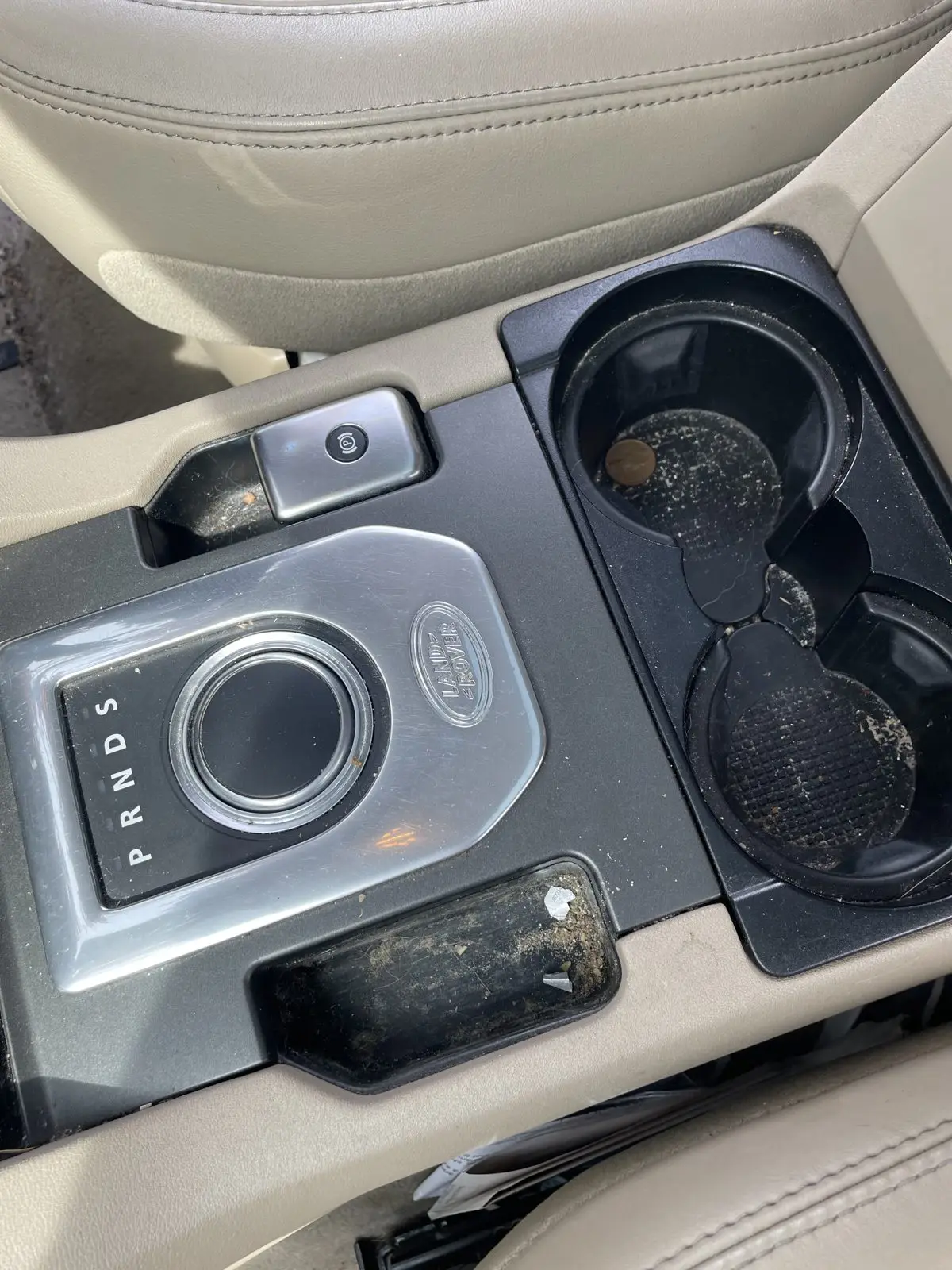 Range Rover centre console before cleaning, with dirt in the switches and seams
