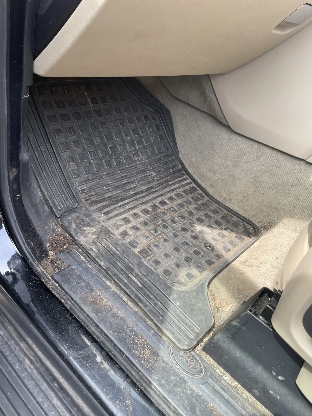 Range Rover footwell before cleaning, carpet heavily soiled
