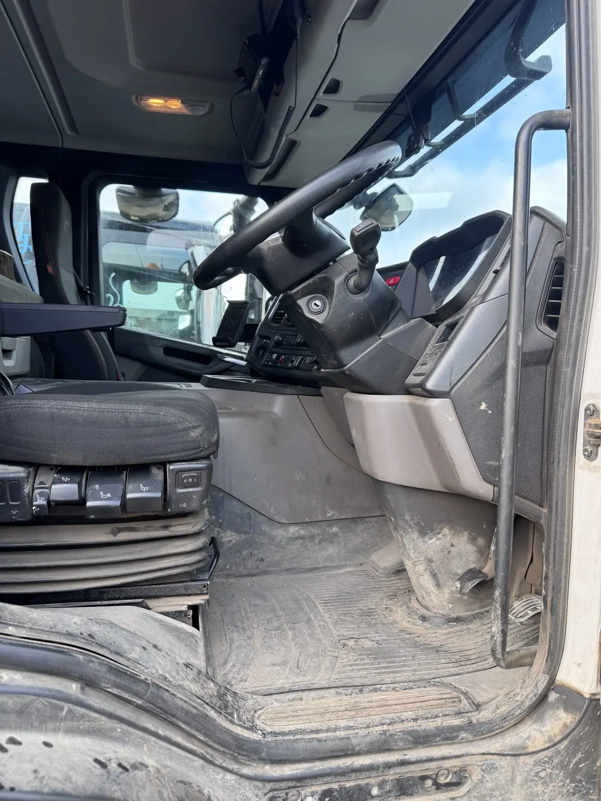 Lorry cab interior before cleaning, with grime built up on the dash and controls