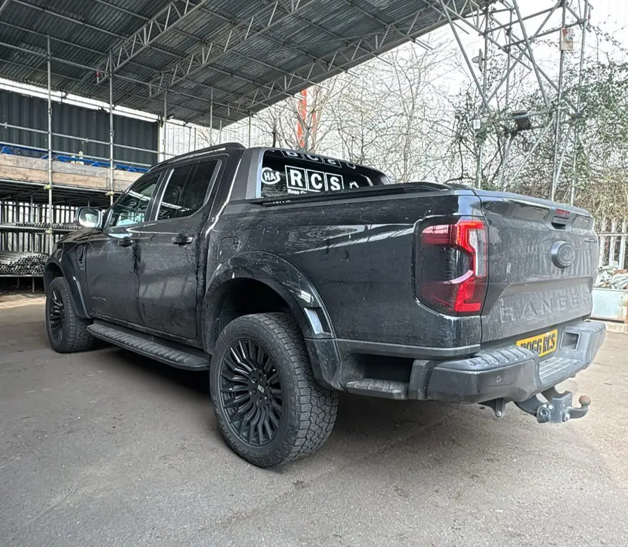 Black Ford Ranger before a maintenance wash, bodywork dulled with road grime