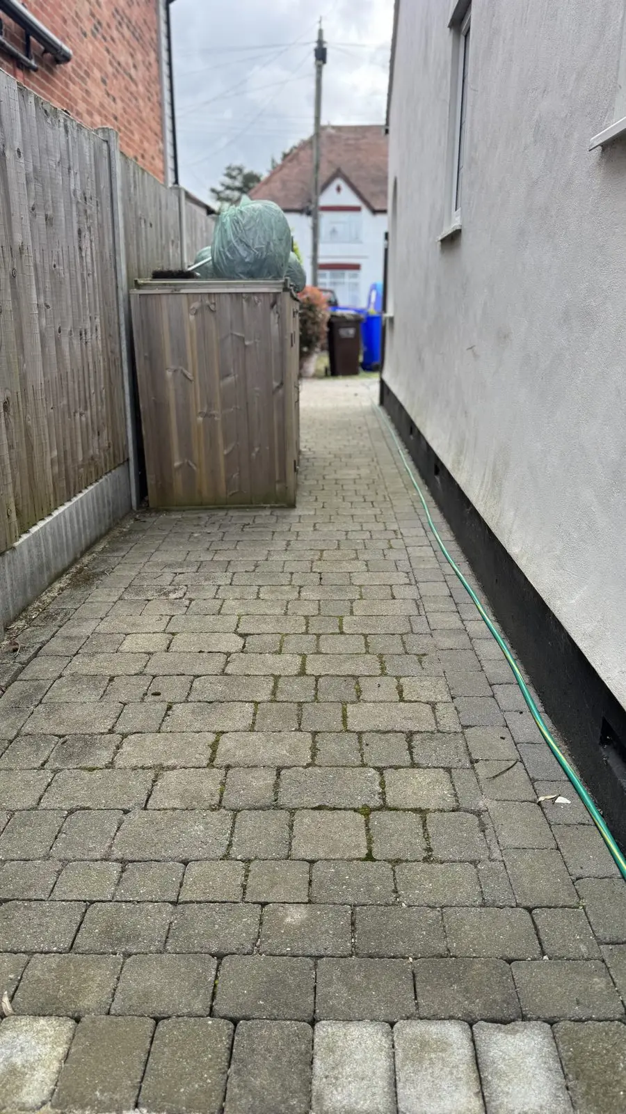 Block paving side path before cleaning, dirty and mossy