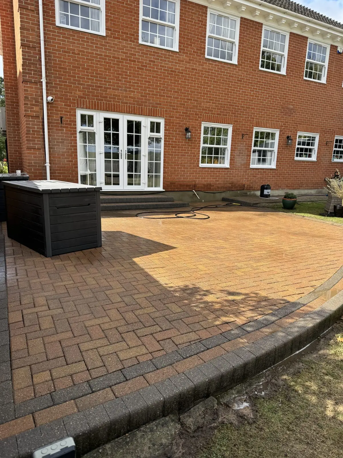 The same block paving patio after cleaning, colour and definition restored