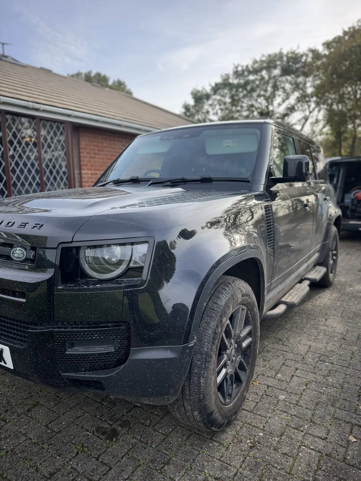 Glossy black Land Rover Defender after a full detail, Essex