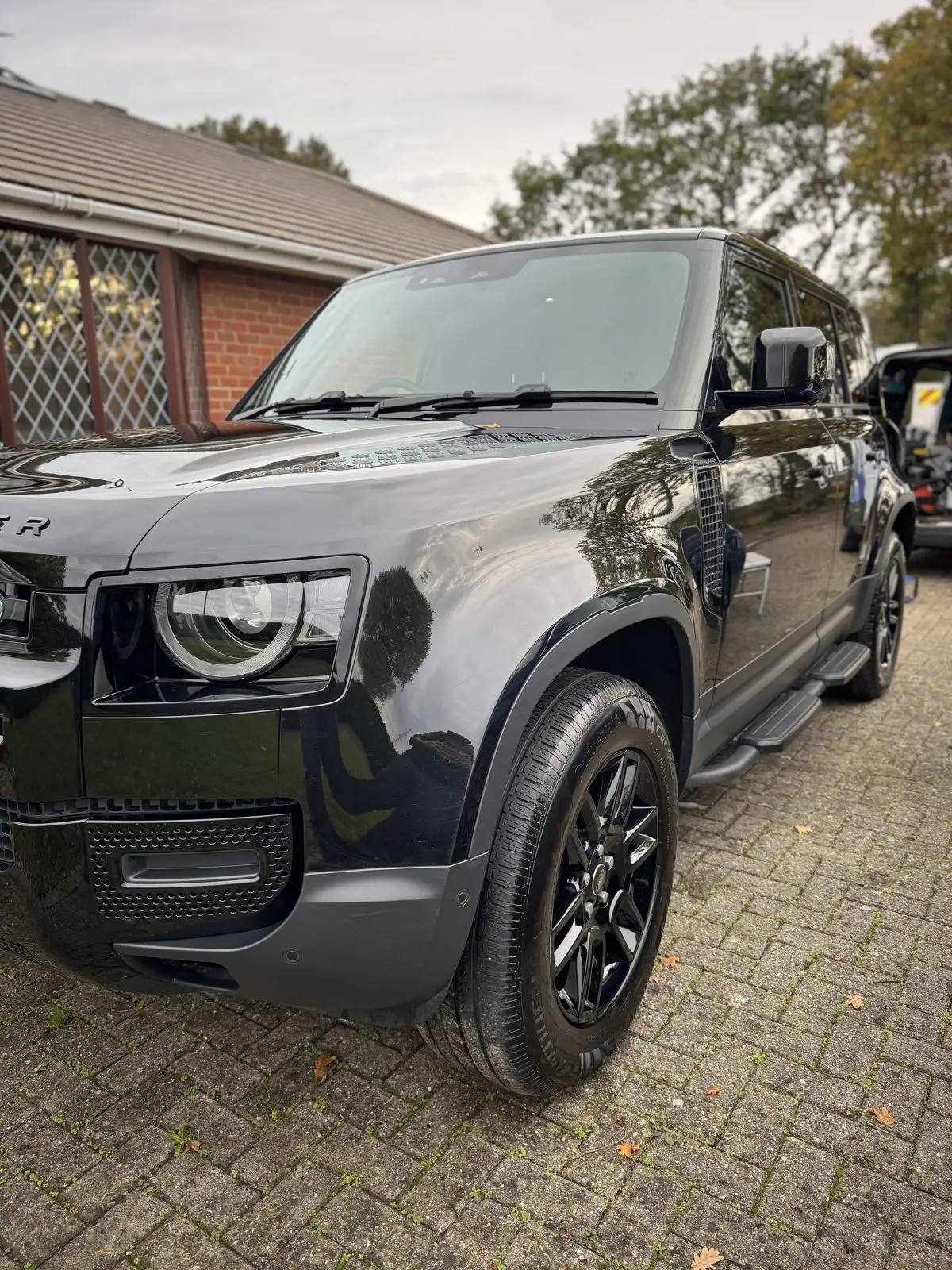 The same Land Rover Defender after detailing, paintwork a deep mirror gloss